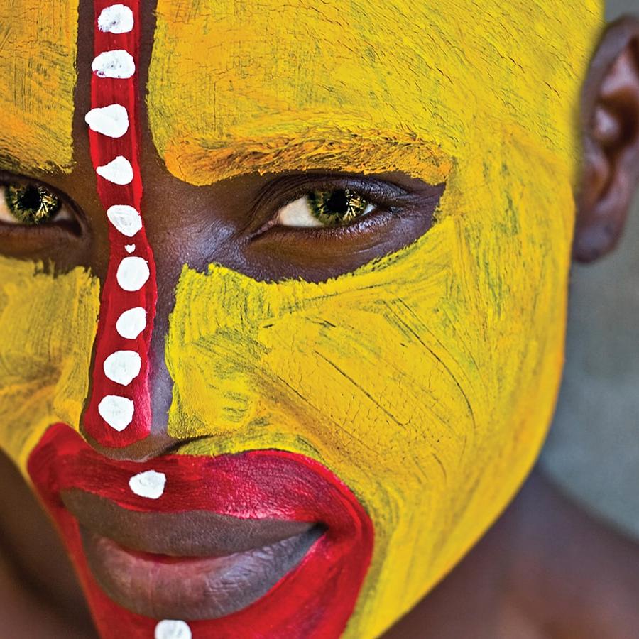 African person with tribal paint on face.