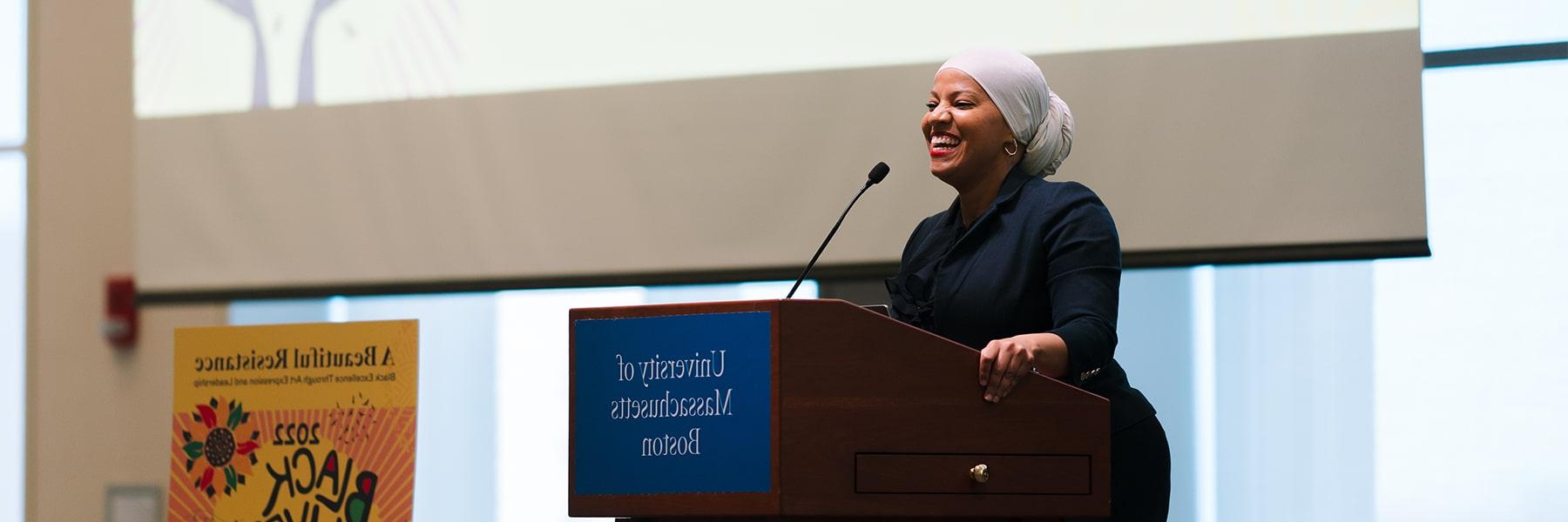 Woman speaks at podium for Black Lives Matter day.