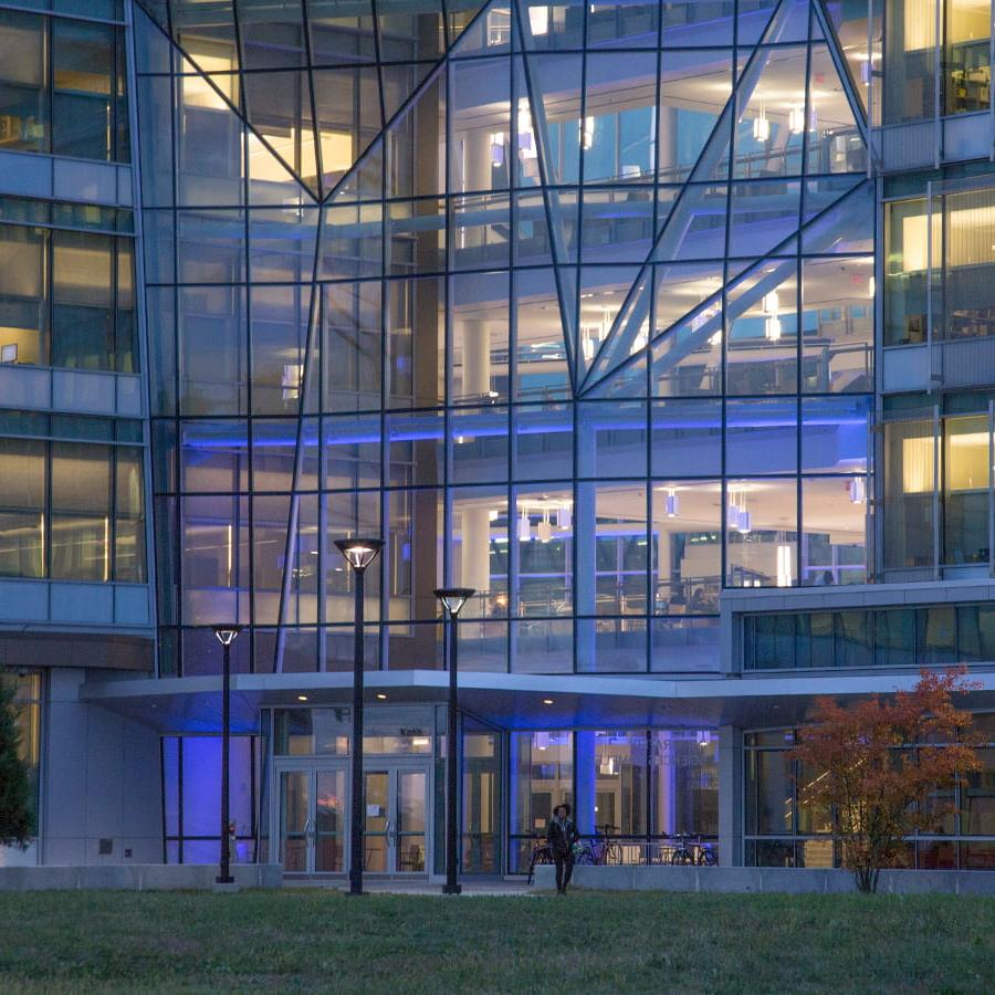 Night view of the Integrated Sciences Complex showing purple lights in building.