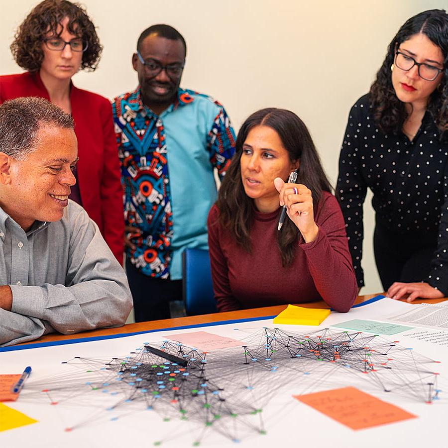 Sustainable solutions colleagues discuss a map.